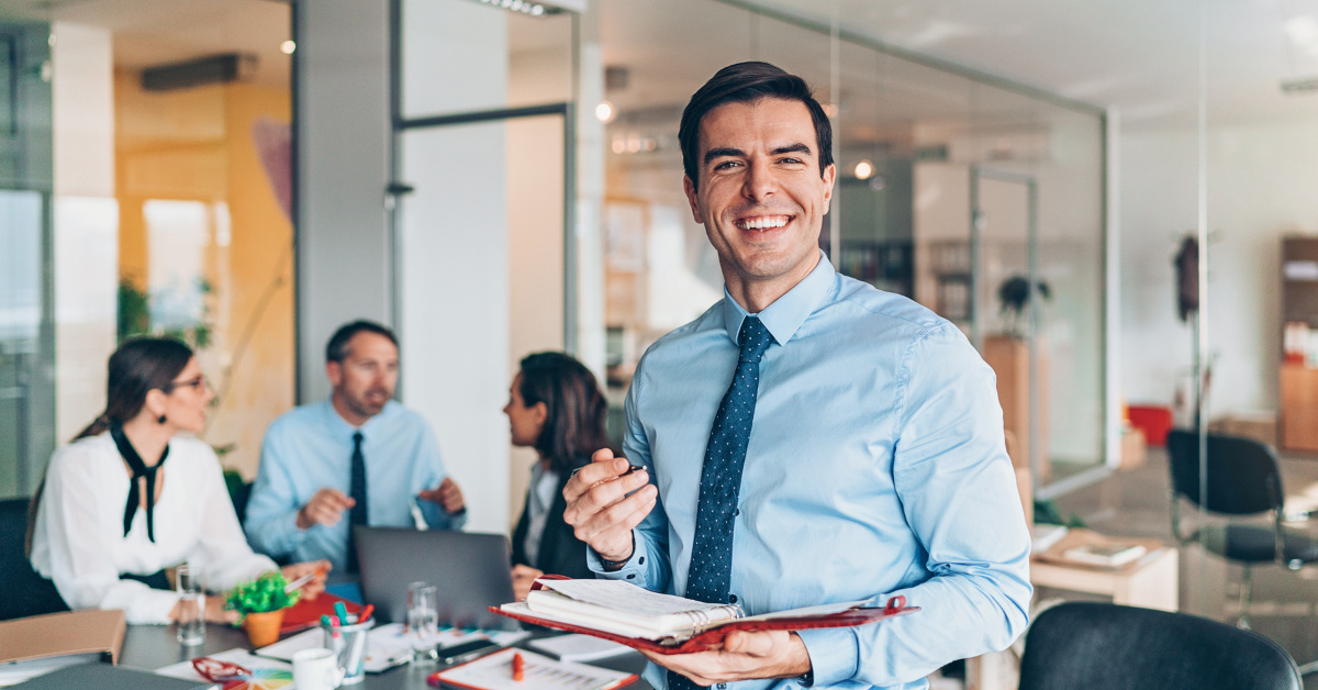 Business team meeting Smiling businessman with colleagues Collaborative office environment