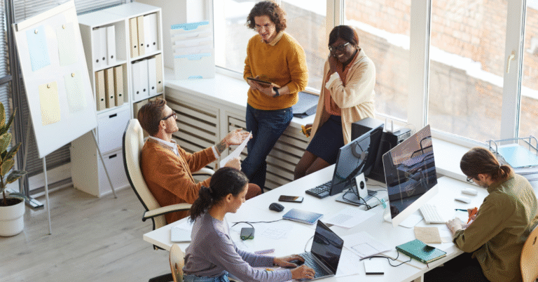 Diverse group of professionals collaborating in a modern office, representing strategies to build an adaptable team.