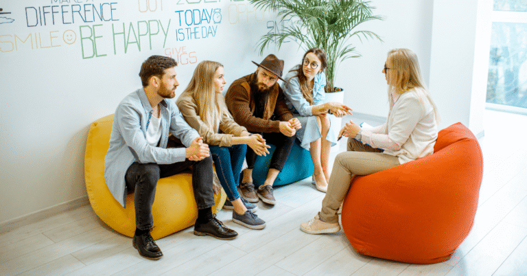 A team of 5 people talking, representing psychological safety.