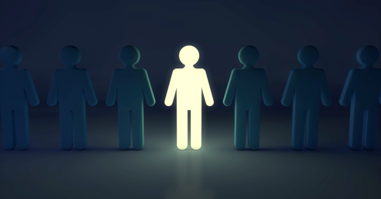 A glowing figure amongst other dark figures representing Leadership Reset