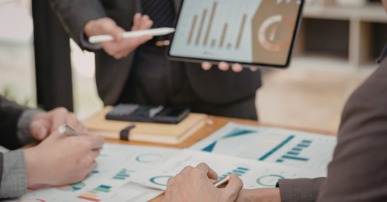 People looking at graphs representing How to Measure Team Performance in a Hybrid World